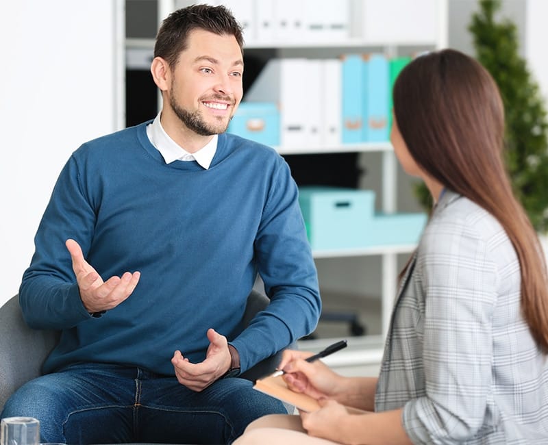 Therapist listening attentively to a patient discussing post-accident emotional recovery